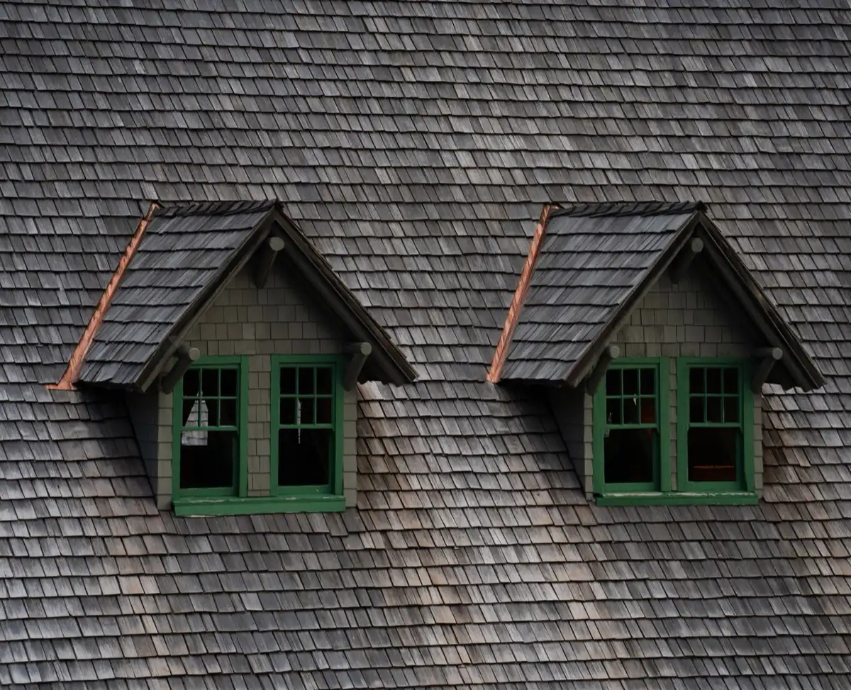 Dormers on a shingle roof in Canton, OH, where step flashing and kickout flashing carry water past the walls